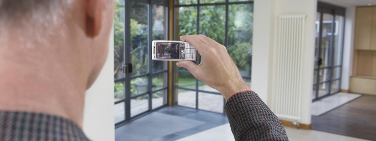 real estate agent taking pictures of a new home listing