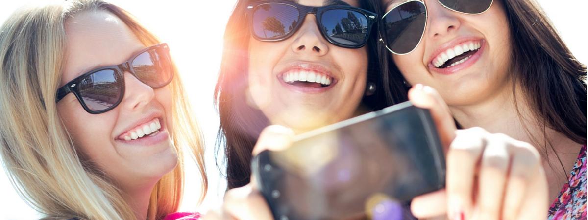 generation y ladies looking at cell phone