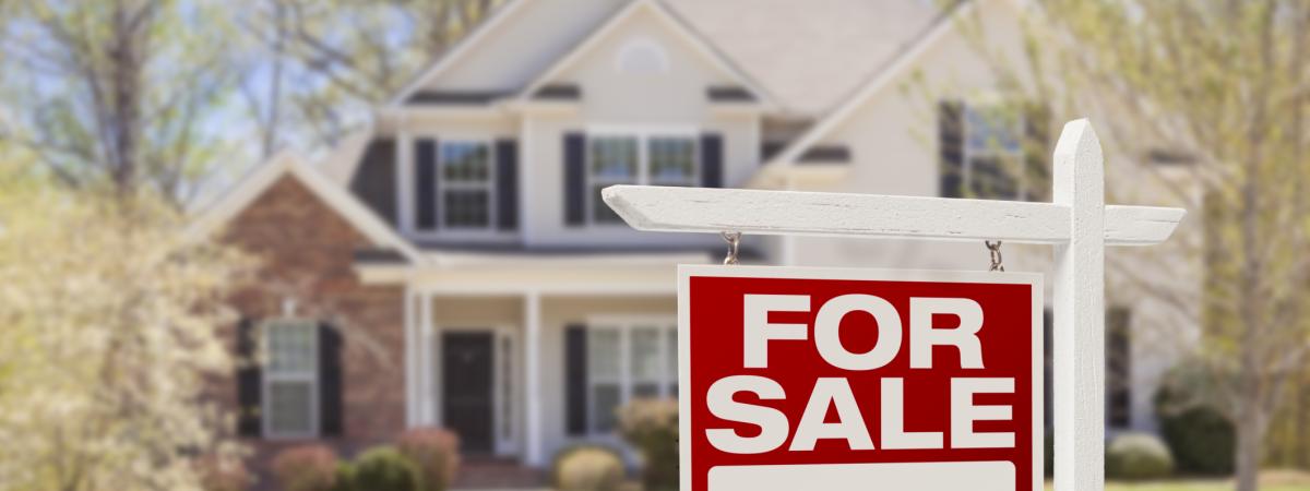 nice home in the country with a for sale sign in front of it