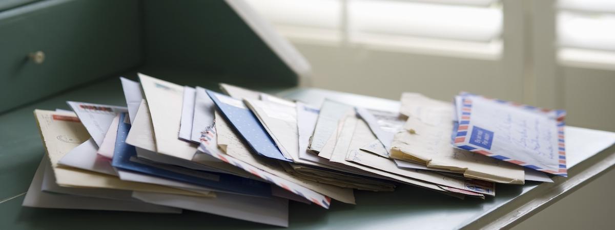 mail on kitchen table with many direct mail marketing flyers