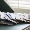 mail on kitchen table with many direct mail marketing flyers